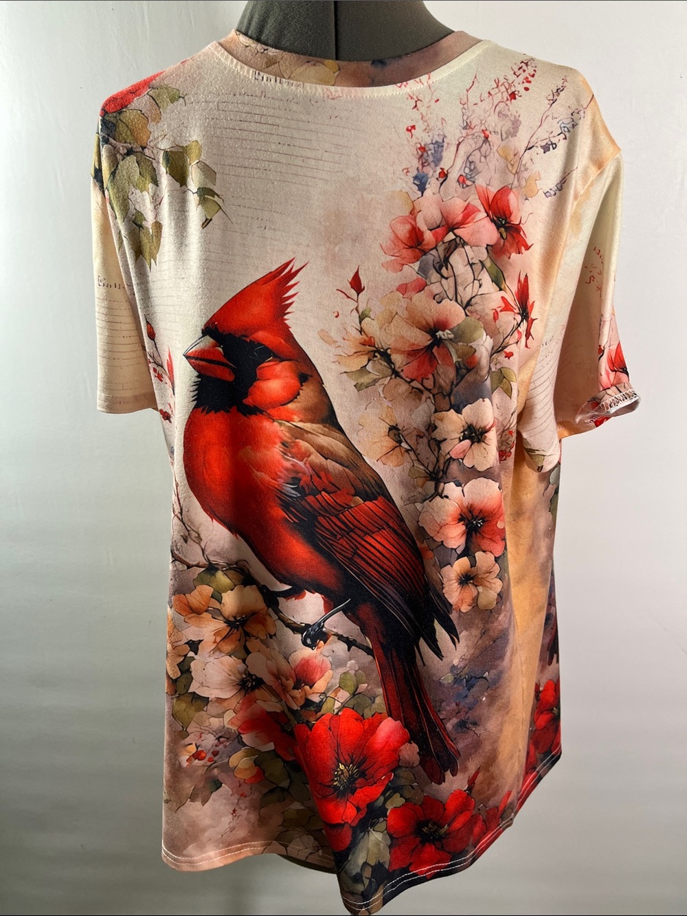 Women short sleeve top w watercolor style of a cardinal perched among flowers